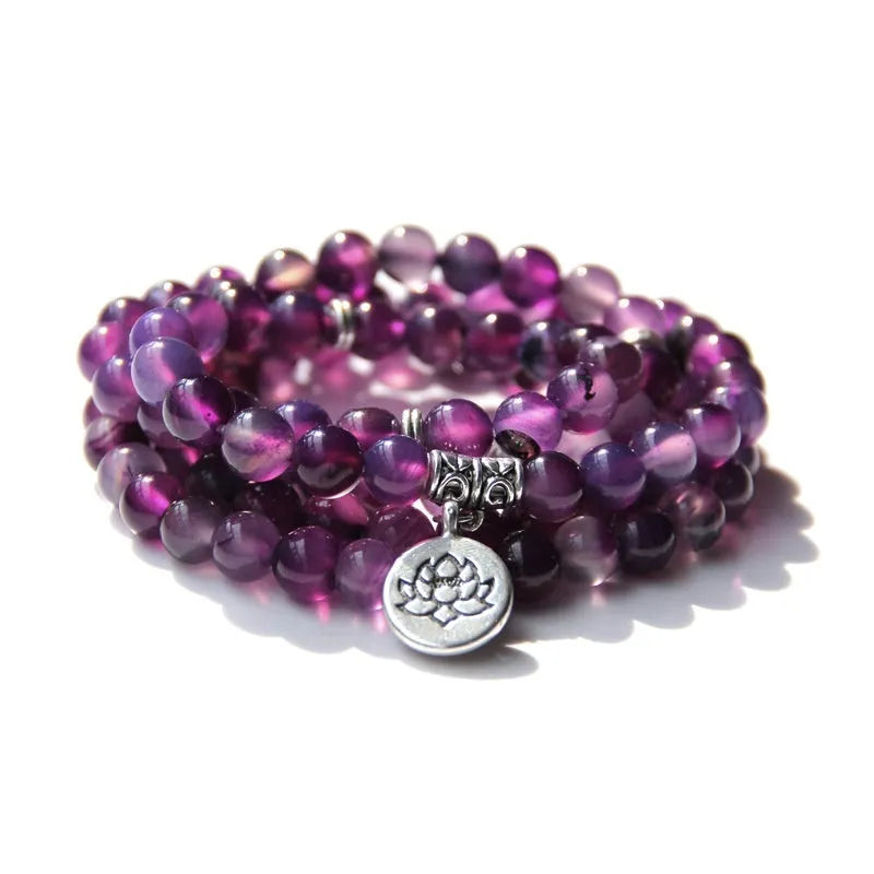 Women's bracelet with natural stone lotus pendant in geometric design showing eight colour variations