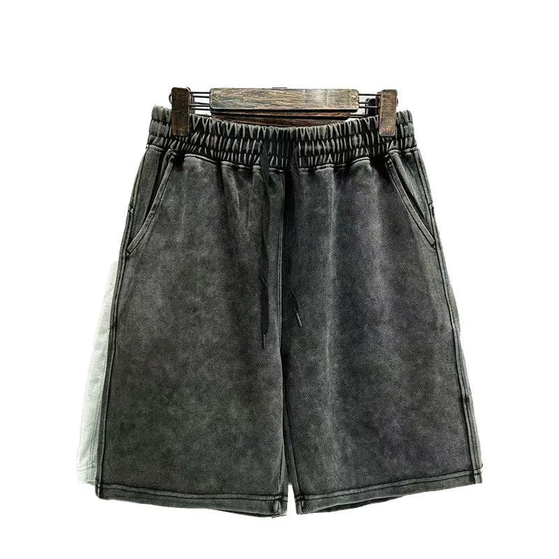 Men's solid colour cotton shorts with distressed detailing on the leg, shown in a loose, straight-leg fit.