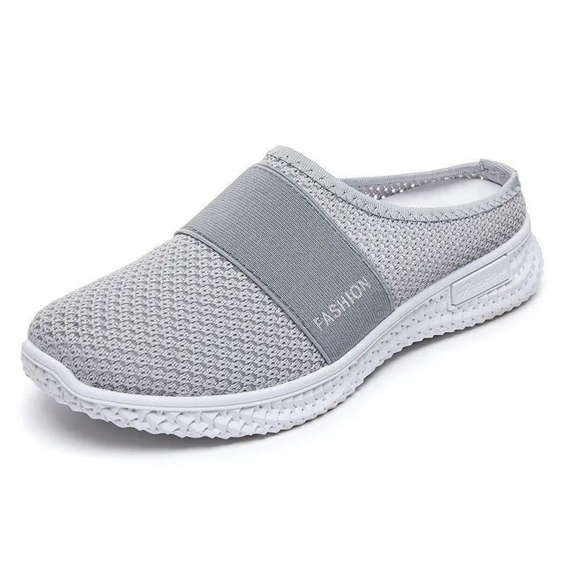 Women's black mesh casual flat shoe with round toe and hollow-out design on a neutral background.