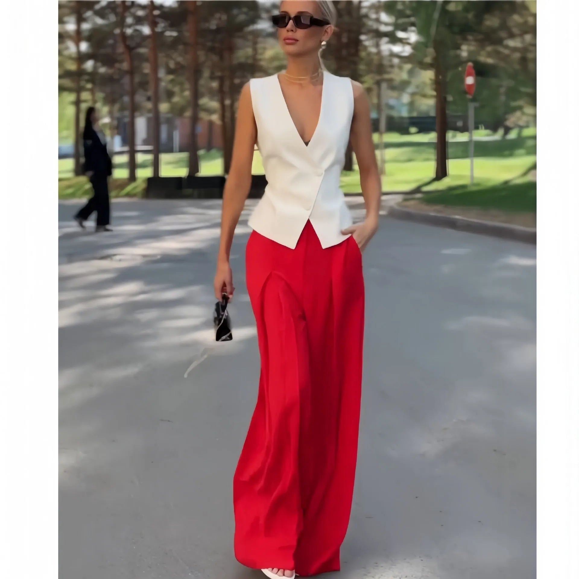 Women's beige polyester two-piece set showing sleeveless V-neck top with high-waist wide-leg trousers