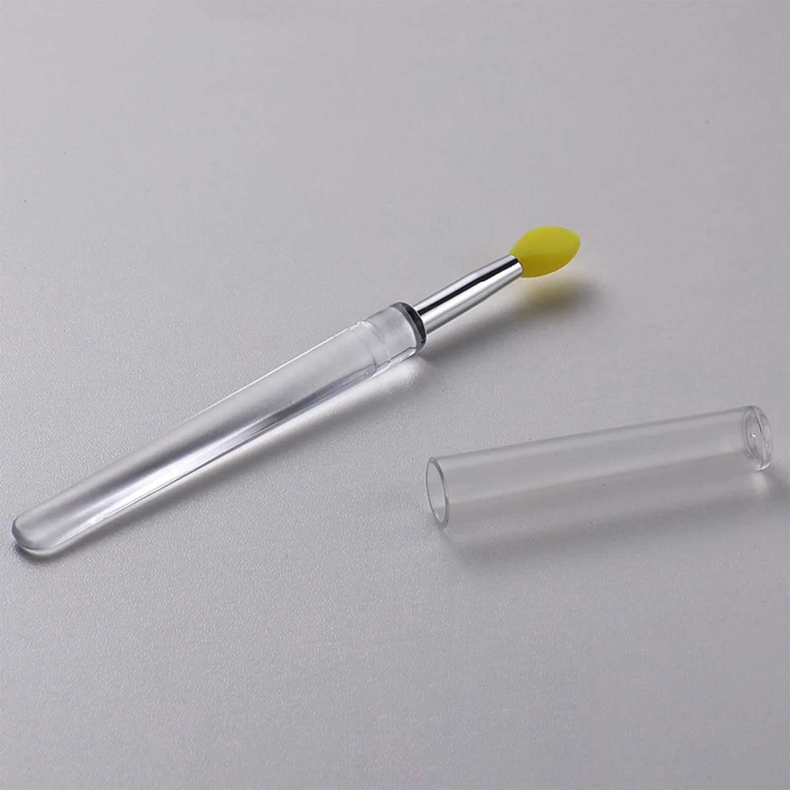 Set of reusable silicone lip brushes with protective caps in various colours.