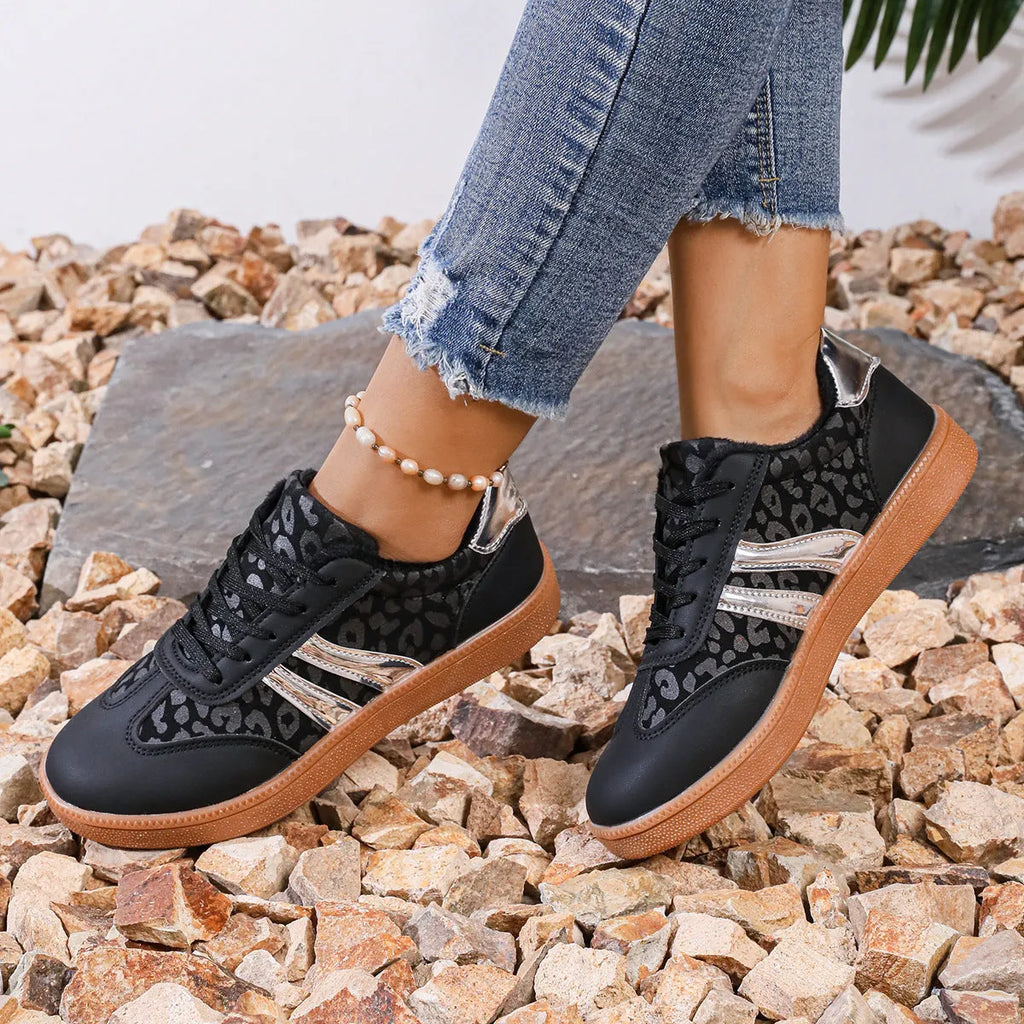 Women's casual running shoes with black microfiber upper, round toe, low top, and rubber sole against white background