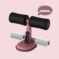 Pink adjustable sit-up bar floor assistant with foam pad and suction base on smooth floor