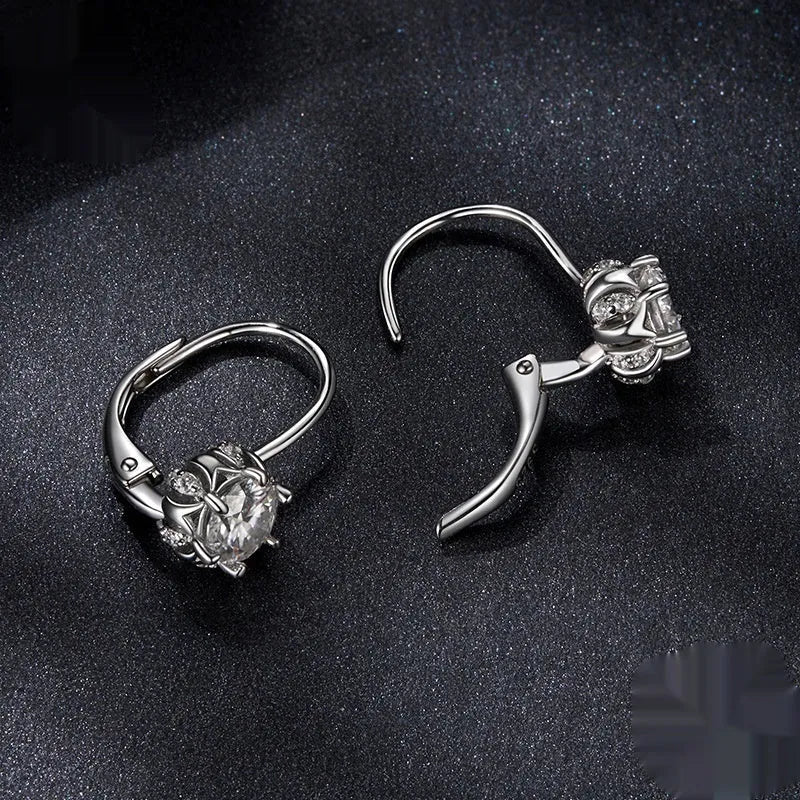 Sterling silver flower bud clip-on earrings with white gold plating and a central moissanite stone.