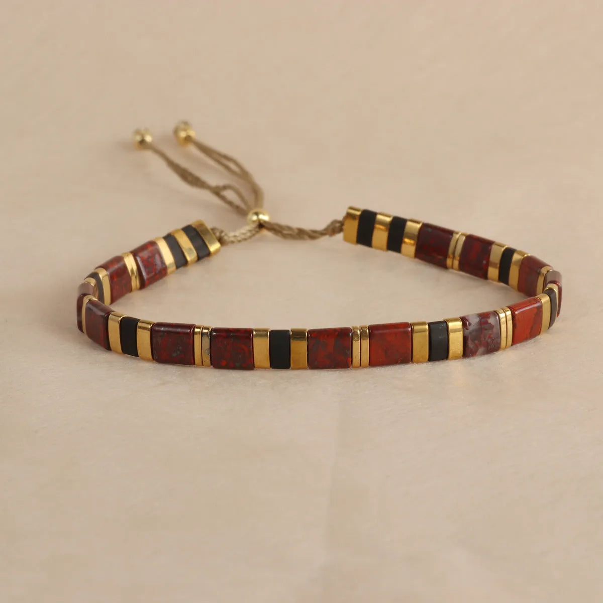 Geometric pull bead bracelet in milky white glass beads on a wrist.