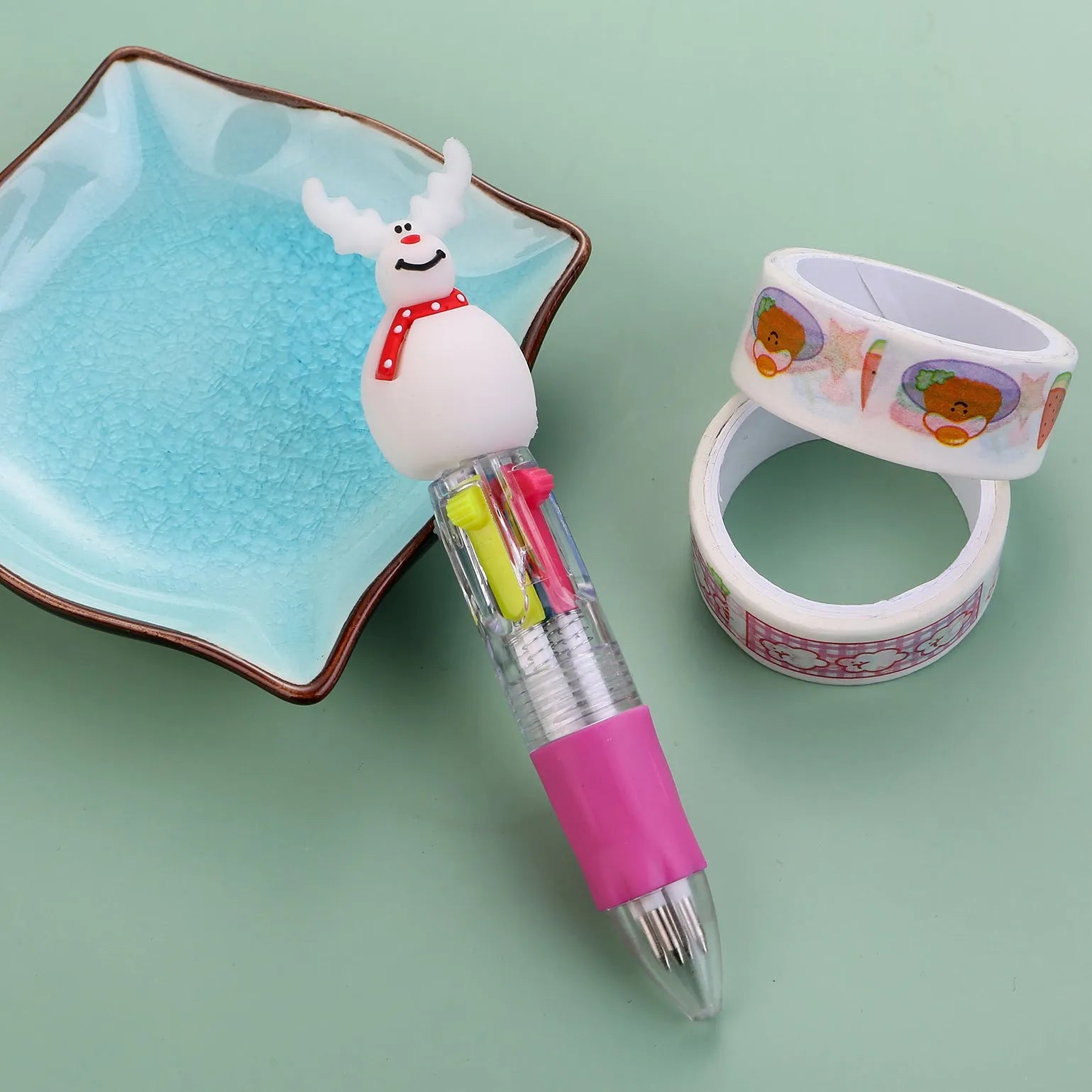 Compact 11cm Christmas-themed press-action ballpoint pen with festive designs.