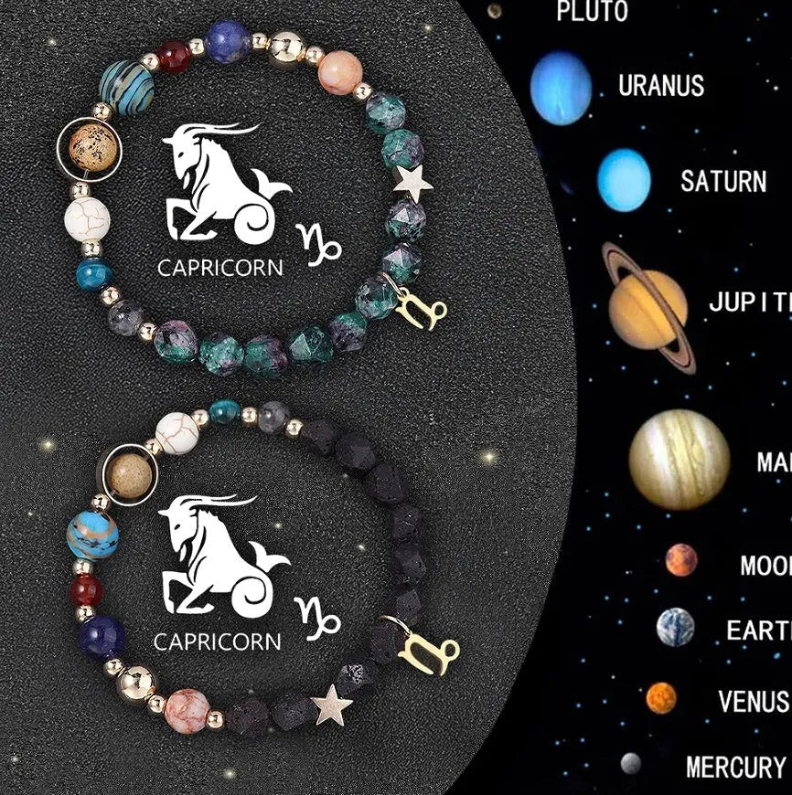 Two natural stone beaded bracelets with zodiac sign charms on a wooden surface.