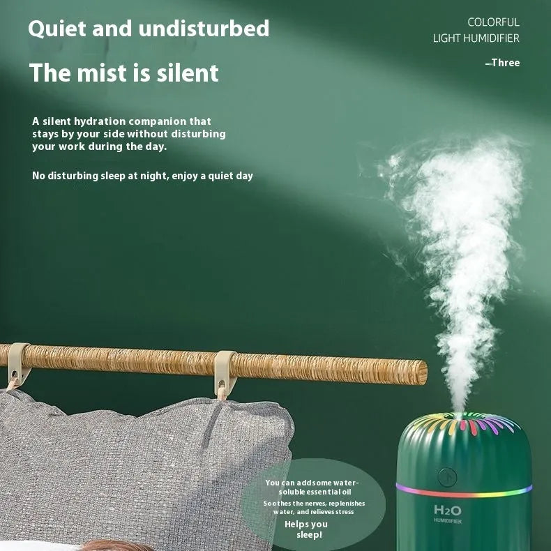 Compact green animal-shaped USB humidifier and aromatherapy diffuser on a desktop