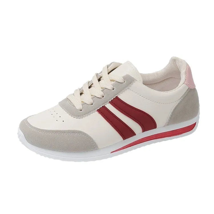 Low-top blue and red lace-up sneakers with mesh upper and rubber sole on a white background