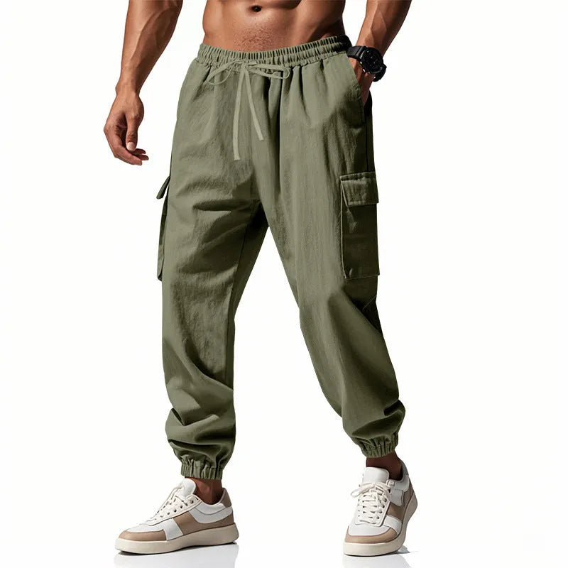 Man wearing khaki linen casual trousers with ankle-tied legs and multiple pockets.