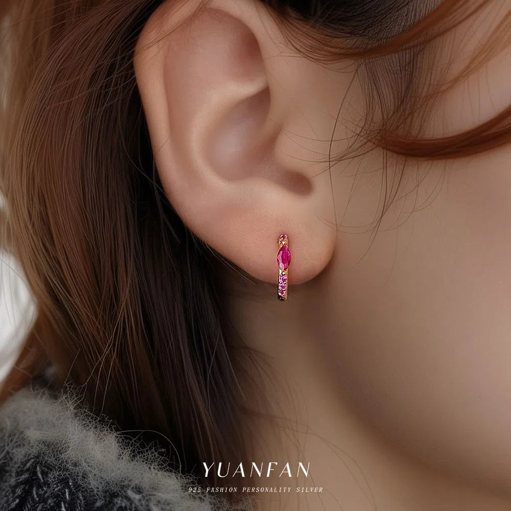 S925 sterling silver geometric earrings with yellow gold finish and inlaid zircon stone on white background