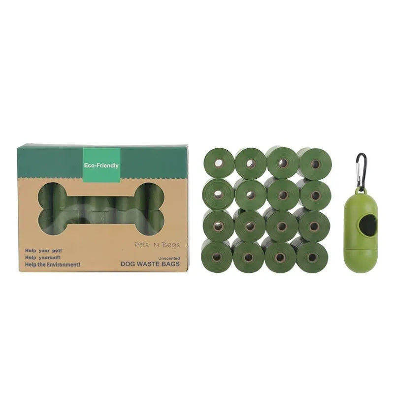 Roll of green EPI degradable dog poo bags next to a white plastic dispenser on a grass background.
