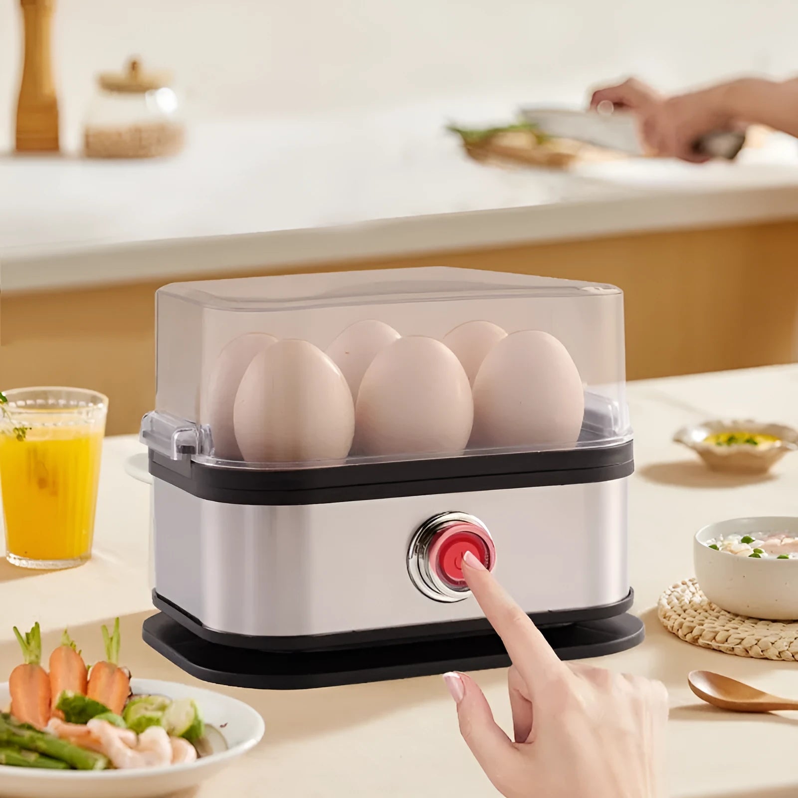 Black stainless steel portable egg boiler with a carry belt on a white background.