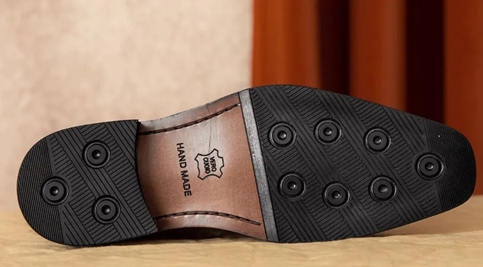 Men's black and brown genuine leather slip-on loafers with a polished finish and rubber sole.