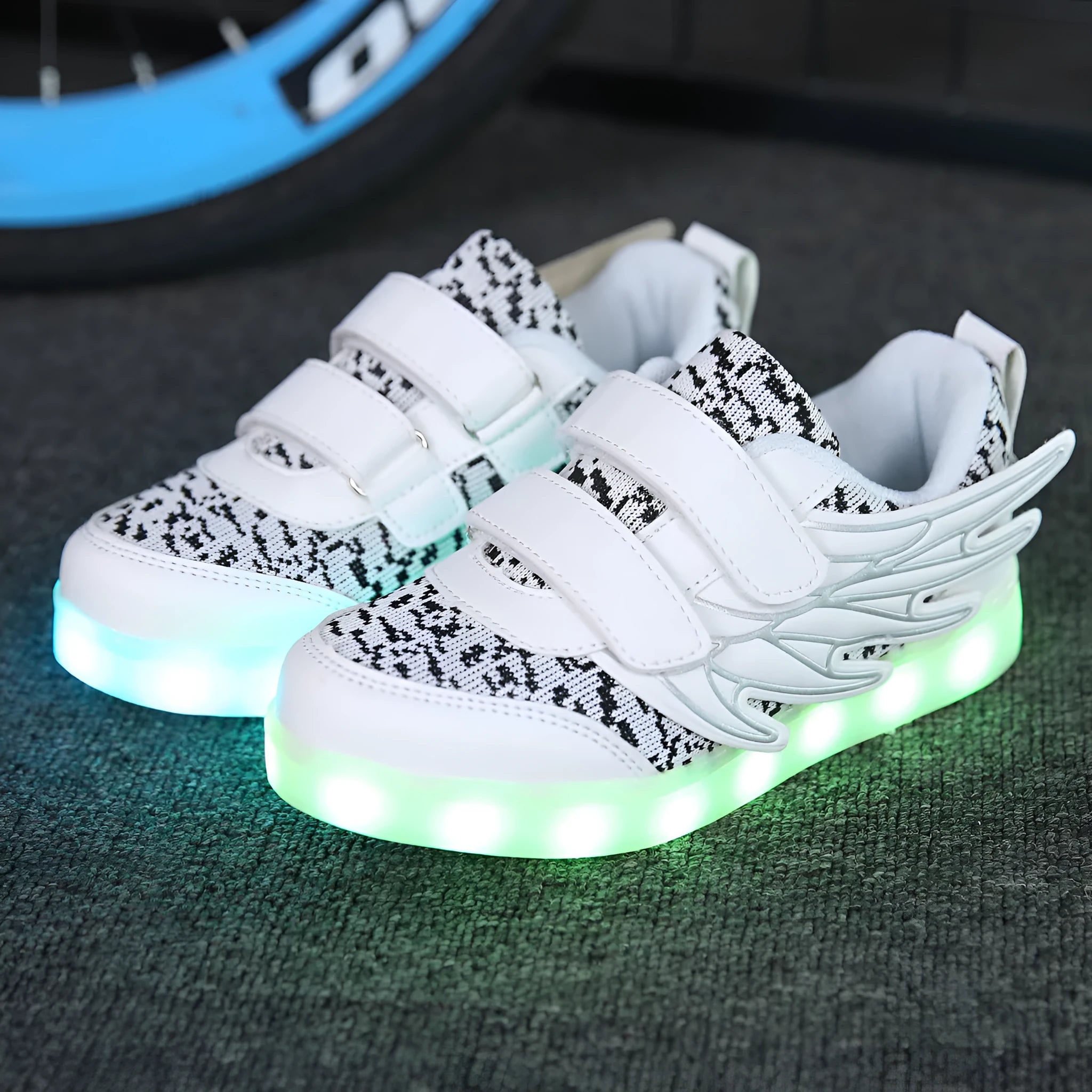Children's plum red and white LED light-up sneakers with USB charging port visible