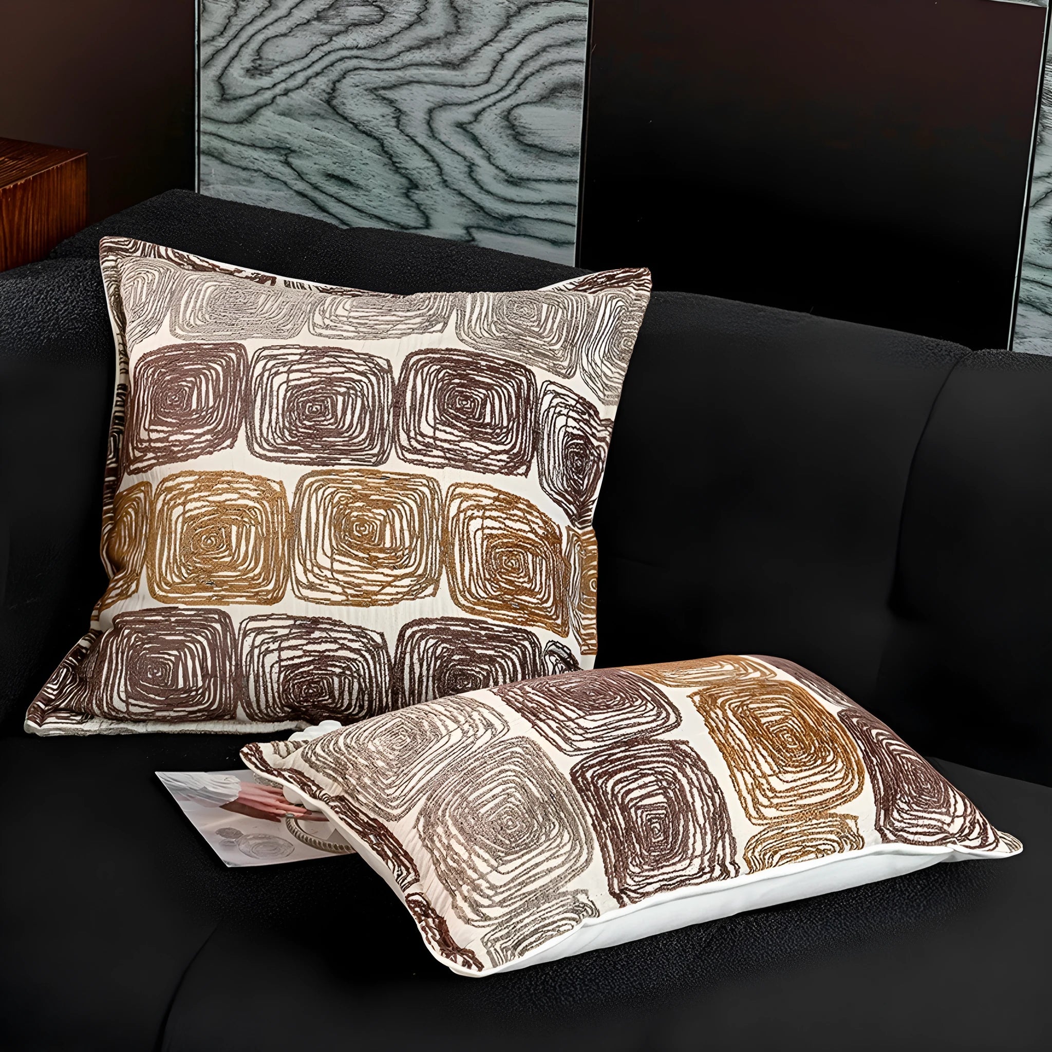 Abstract coil pattern pillow cover in cream and coffee colours on grey sofa