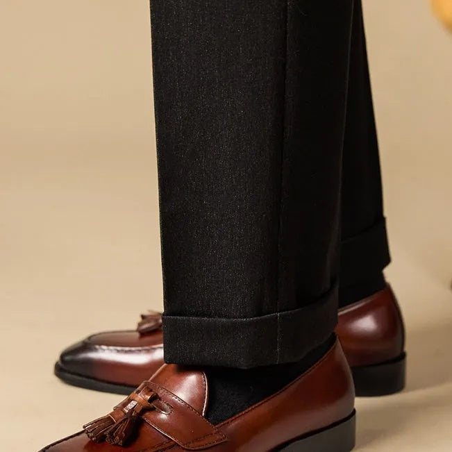 Men's black and brown polished leather tassel loafers with pigskin lining and rubber soles