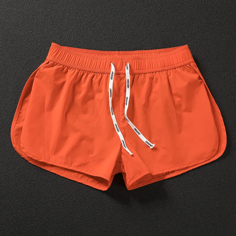 Men's loose fit beach shorts in fluorescent green, orange red, and black colours with micro-elastic polyester fabric