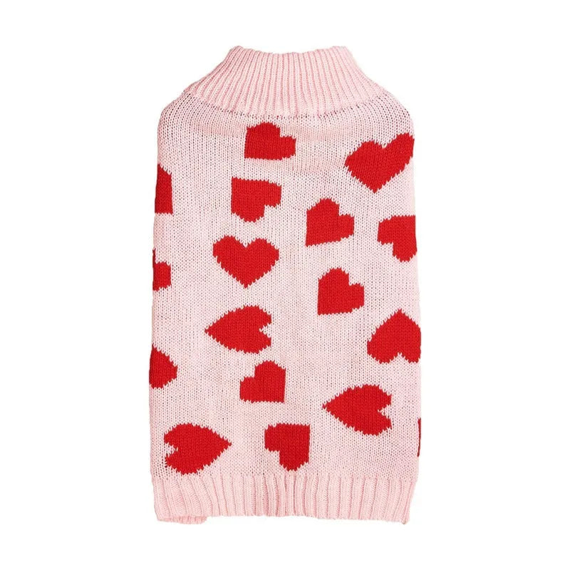 Dog wearing red love heart patterned sweater in acrylic knit fabric