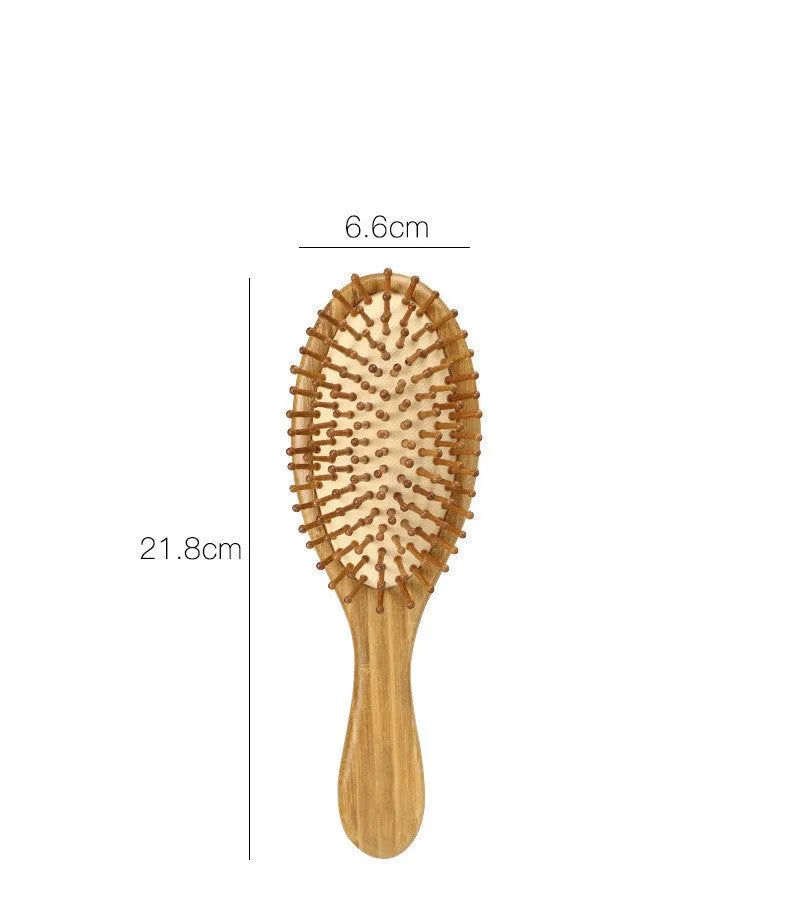Carbonised bamboo massage comb 66x218mm on neutral background with smooth wooden surface visible