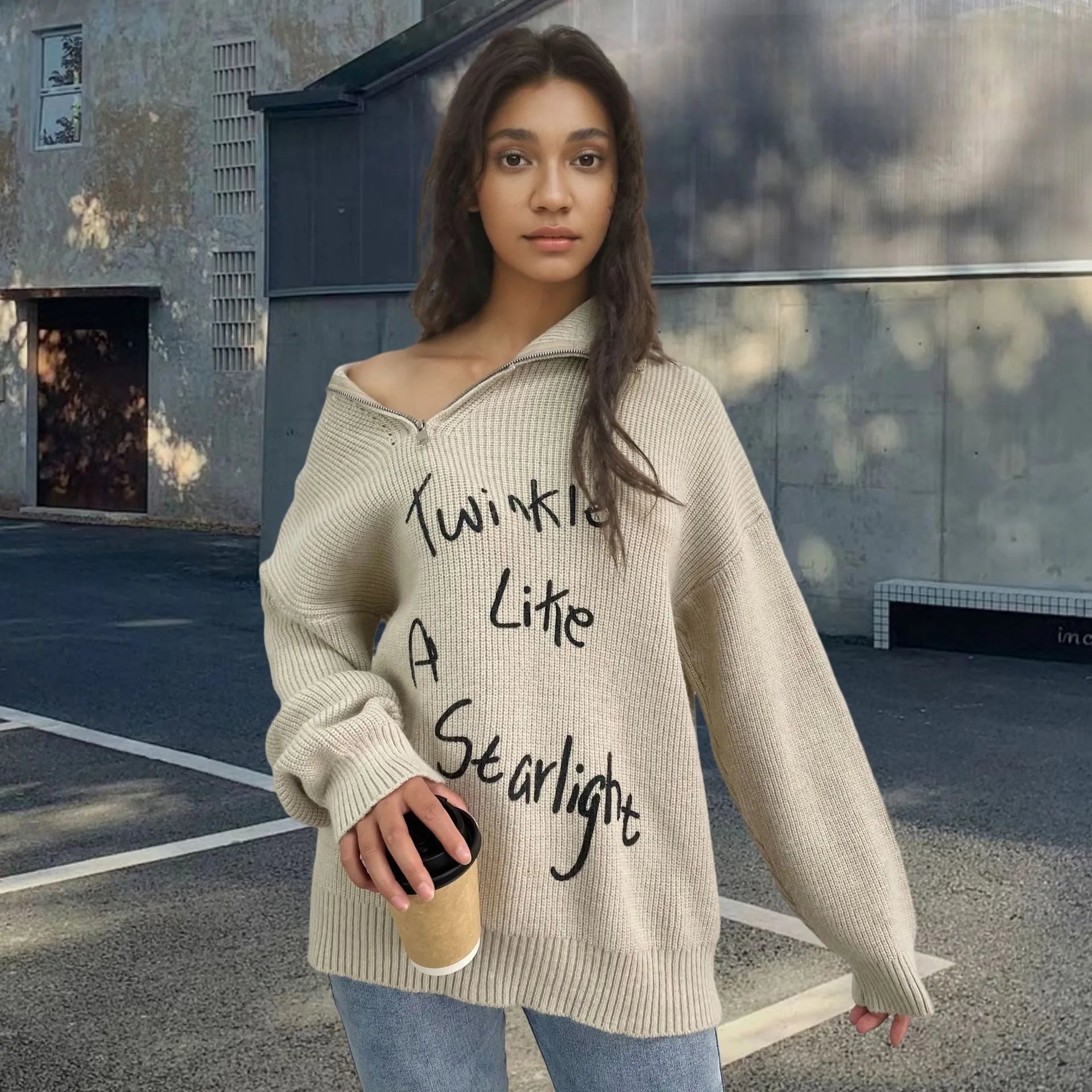 Woman wearing a light khaki retro turtleneck sweater with loose lapels and an oblique diagonal zipper detail.
