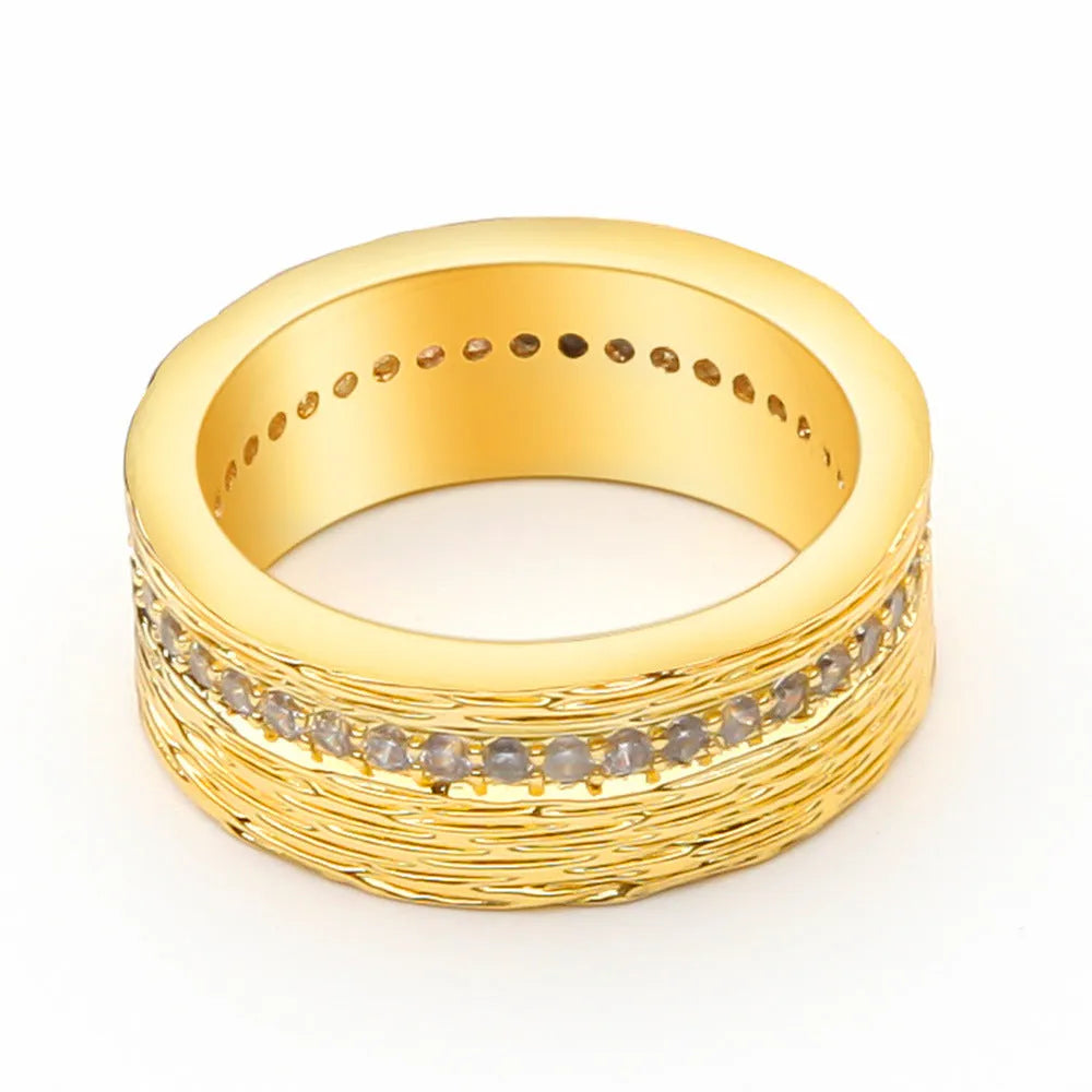 Gold geometric women's ring with clear zircon stone on copper band.