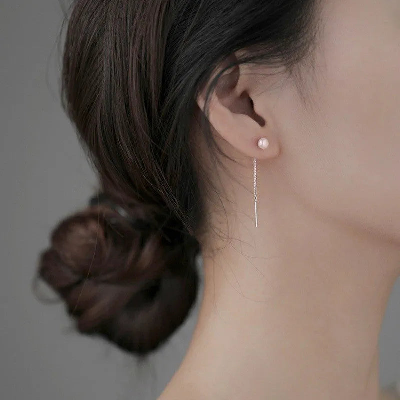 Long sterling silver needle ear string with a choice of geometric or pearl pendants for women.