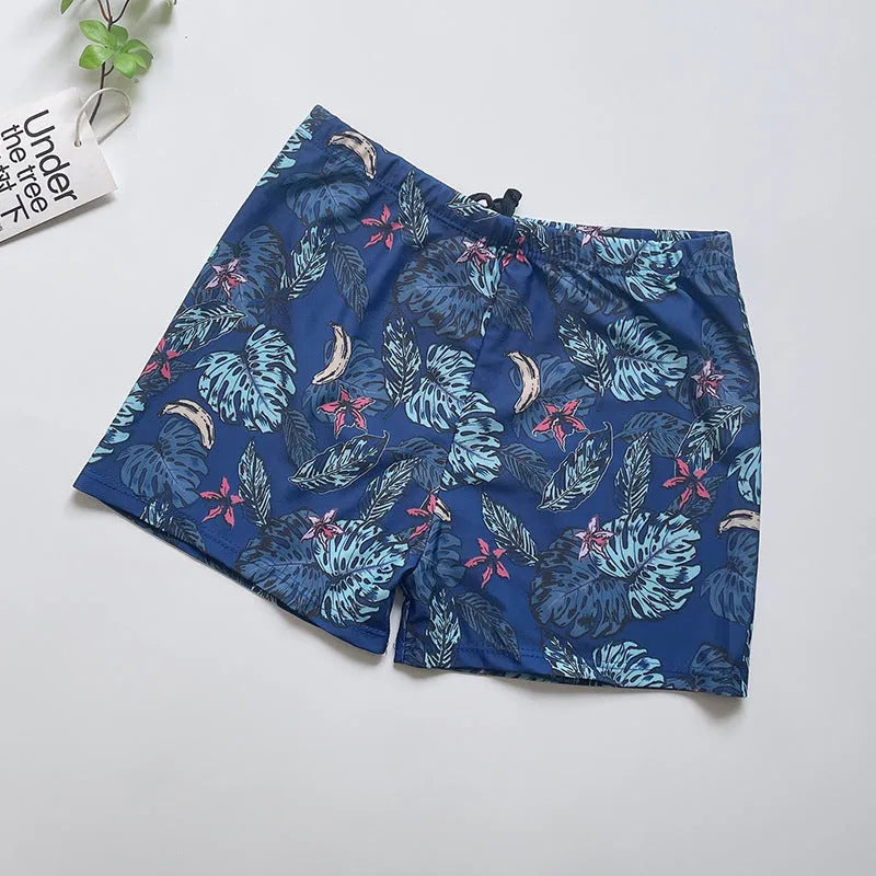Men's loose-fit polyester swim trunks in dark blue with large flower print, three sizes available