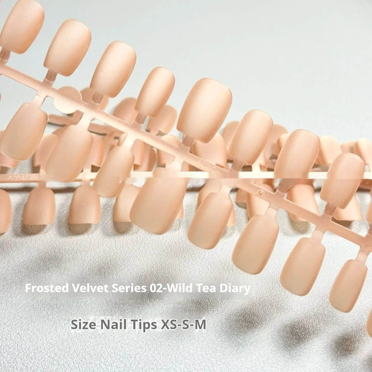 Short ladder false nails with velvet frosted Cat's Eye finish in XS S M sizing options showing Aurora designs