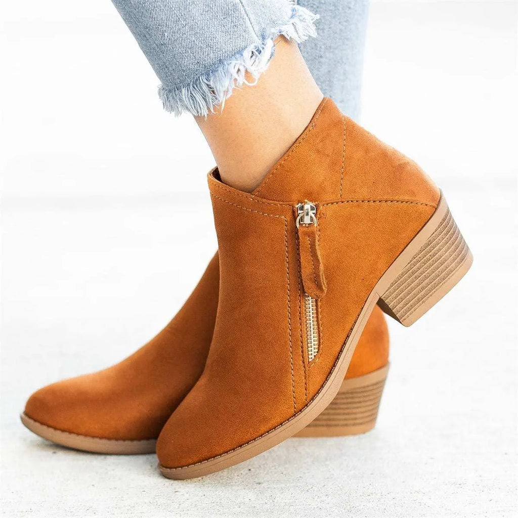 Blue suede women's ankle boots with a chunky heel and side zip closure on a white background.
