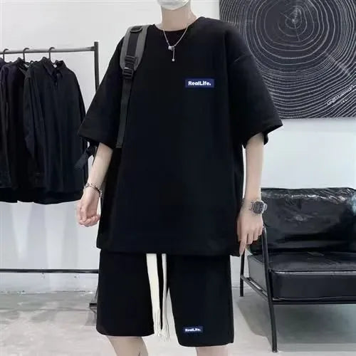 Man wearing a grey waffle-textured short sleeve top and matching shorts leisure set.