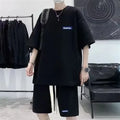 Man wearing a grey waffle-textured short sleeve top and matching shorts leisure set.