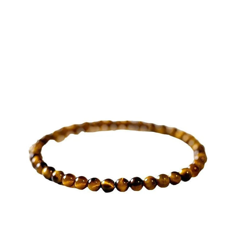 Tigereye stone bracelet with geometric Chinese design showing round elements and bead detailing