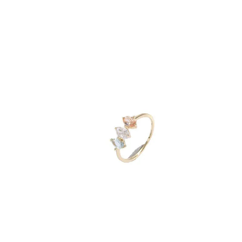 Geometric birthstone ring with horse eye shaped tricolor zircon stones in gold colour