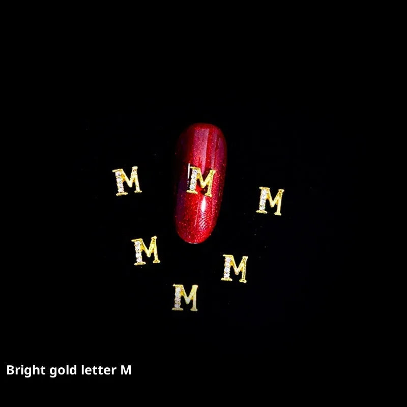 Gold alloy letter A nail ornament charm with crystal detail on a square chain base