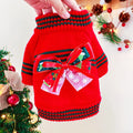 Red polyester Christmas dog jumper on small dog showing festive patterns and pullover design