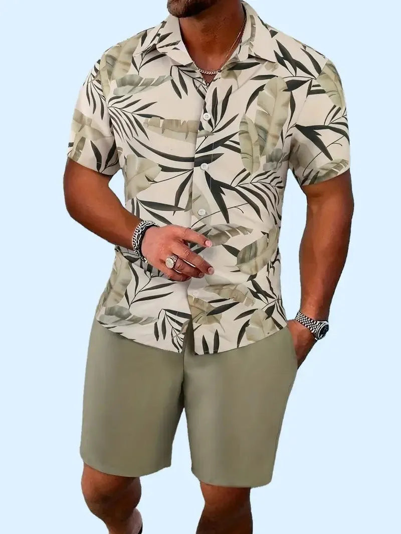 Man wearing a blue Hawaiian print short sleeve shirt and matching shorts from the casual suit set.