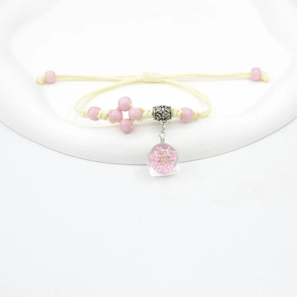 Hand-woven glass bracelet with 1.4cm beads containing real dried flowers in various colours
