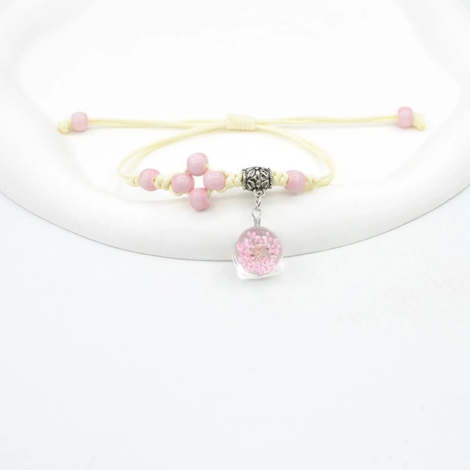 Hand-woven glass bracelet with 1.4cm beads containing real dried flowers in various colours