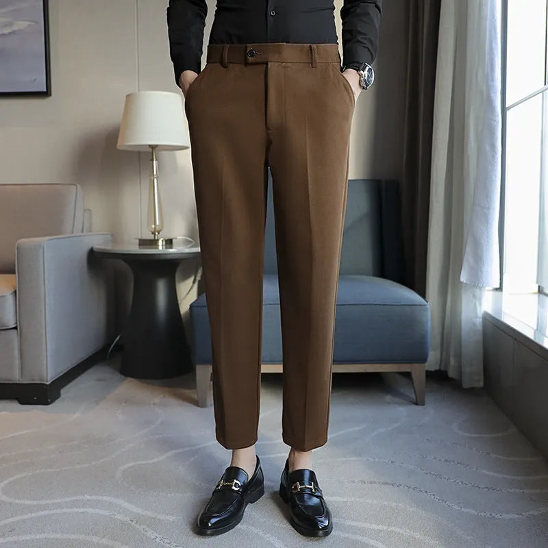 Retro brown straight leg corduroy trousers with elastic waistband laid flat.