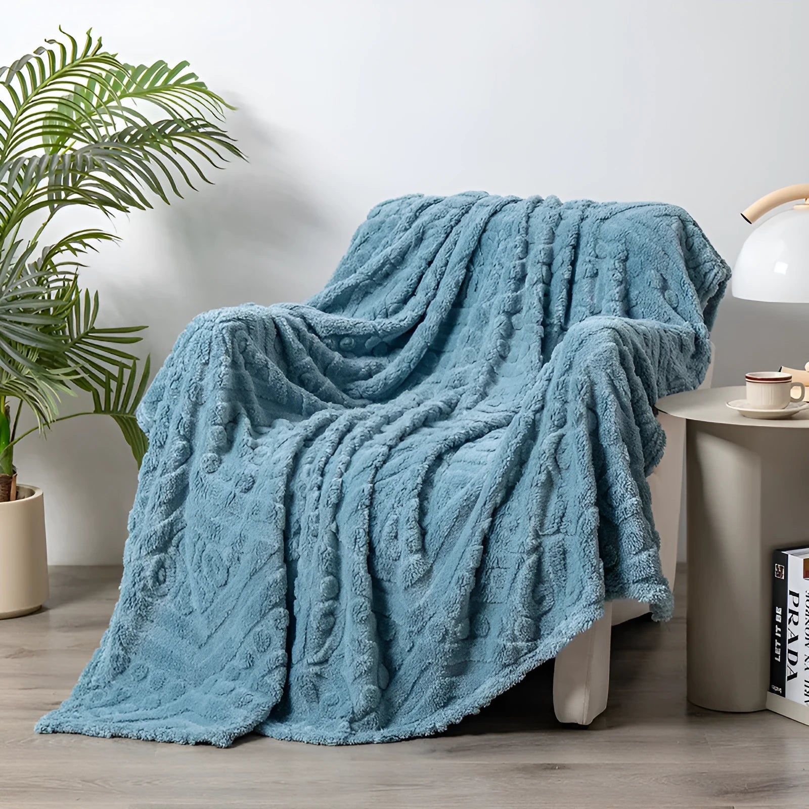 Shu Cotton Velvet Jacquard blanket in fog blue with a woven plant flower pattern, laid flat.