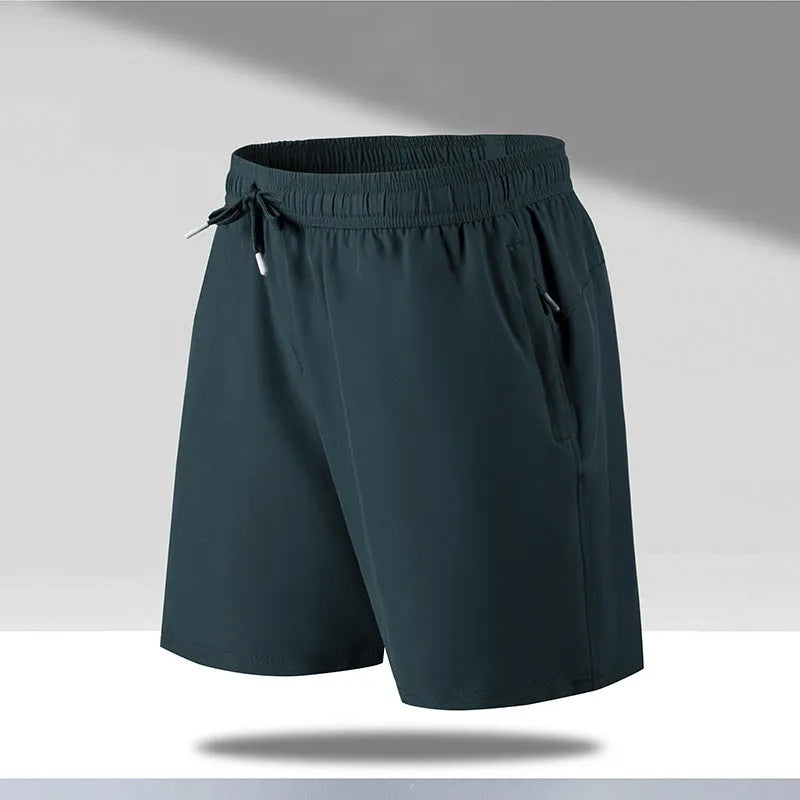 Man wearing loose-fit black quick-drying polyester beach shorts with a micro-elastic waistband.