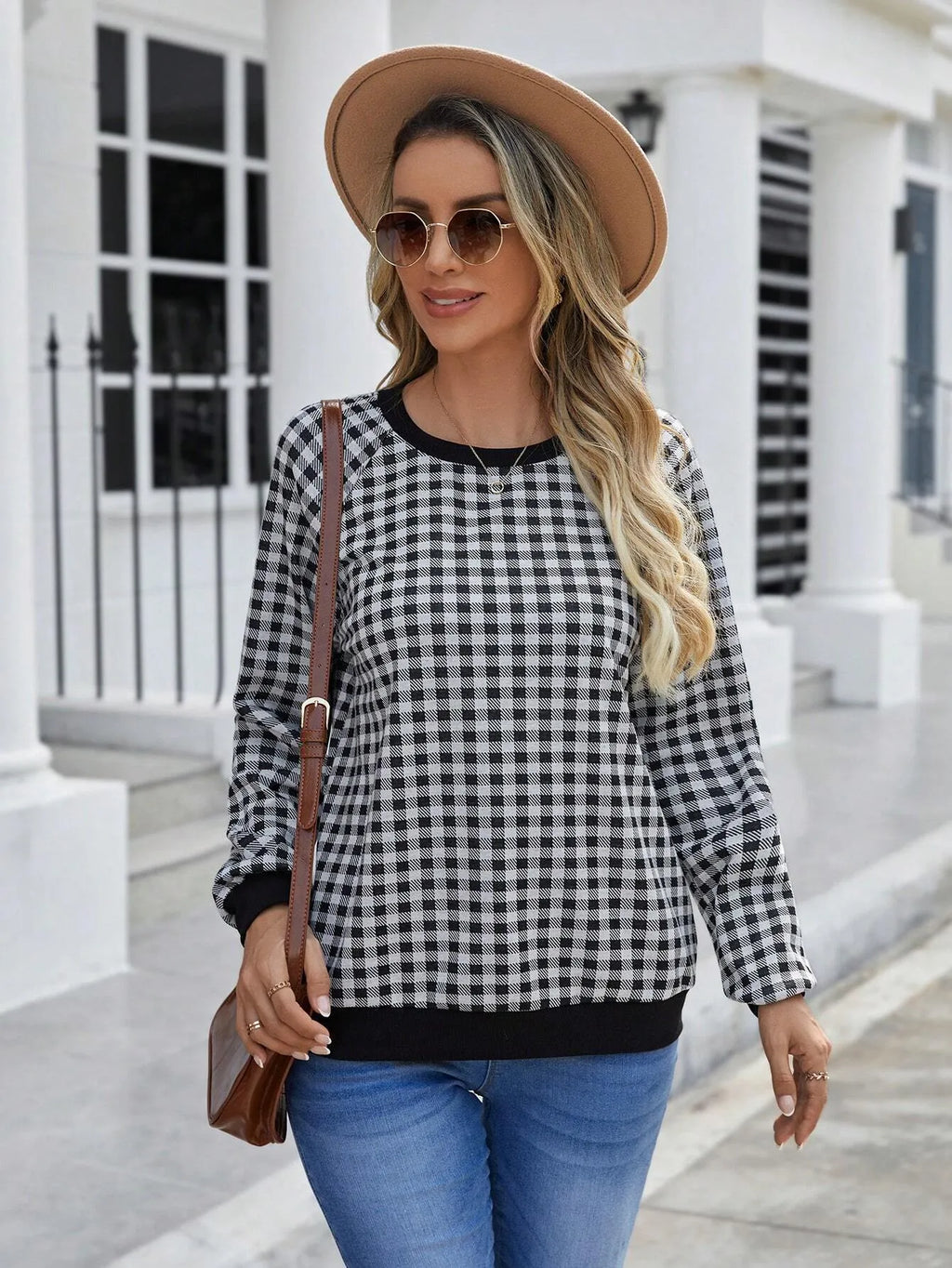 Black long sleeve pullover sweater with plaid pattern and printing detail showing front view