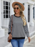 Black long sleeve pullover sweater with plaid pattern and printing detail showing front view