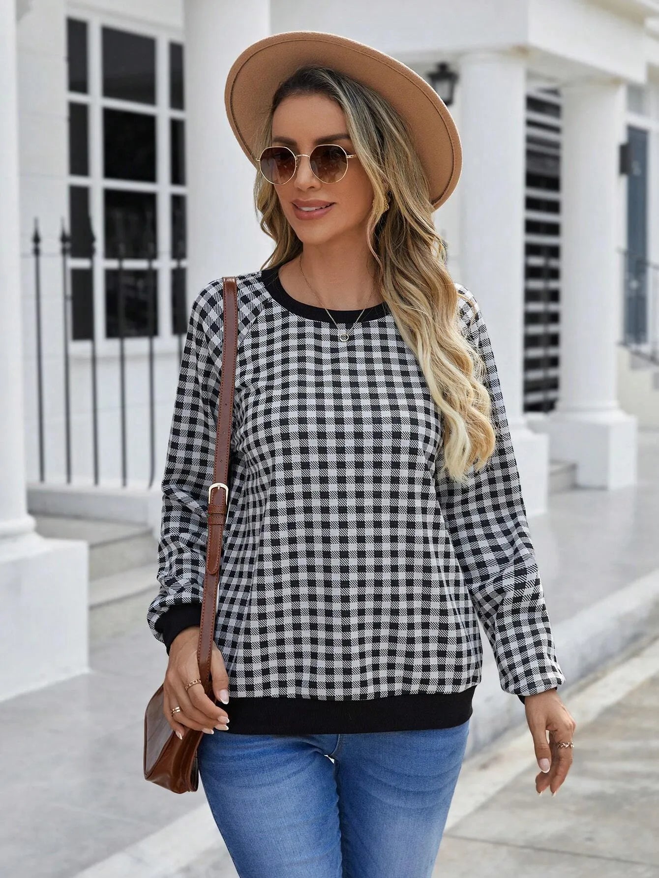 Black long sleeve pullover sweater with plaid pattern and printing detail showing front view
