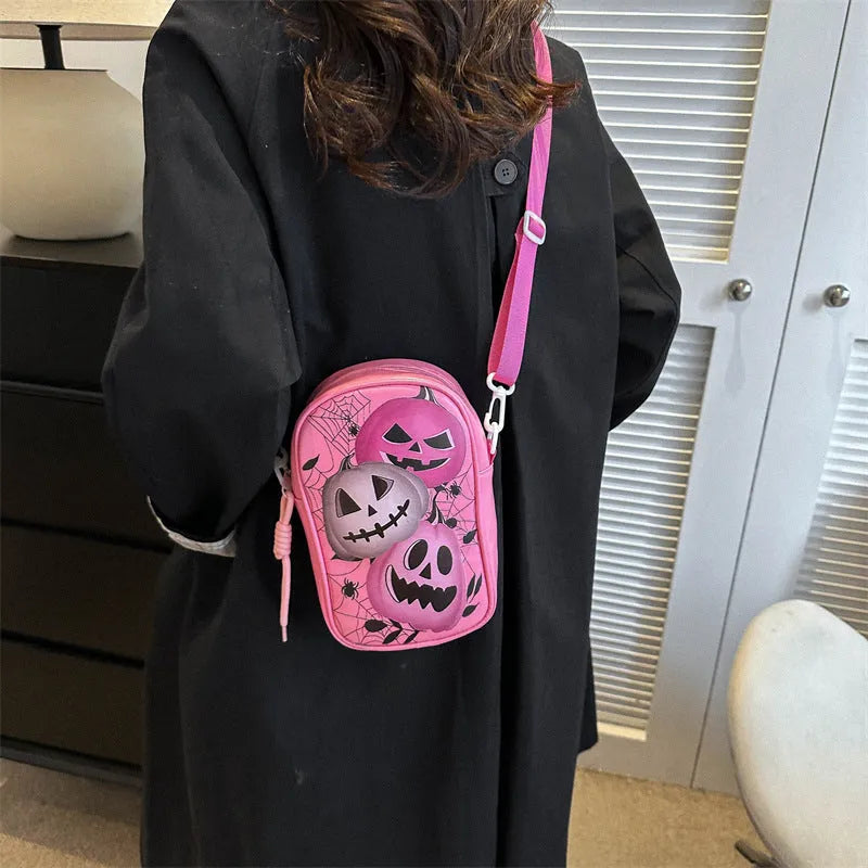 Black Halloween graffiti crossbody bag with pumpkin, ghost, and bat print