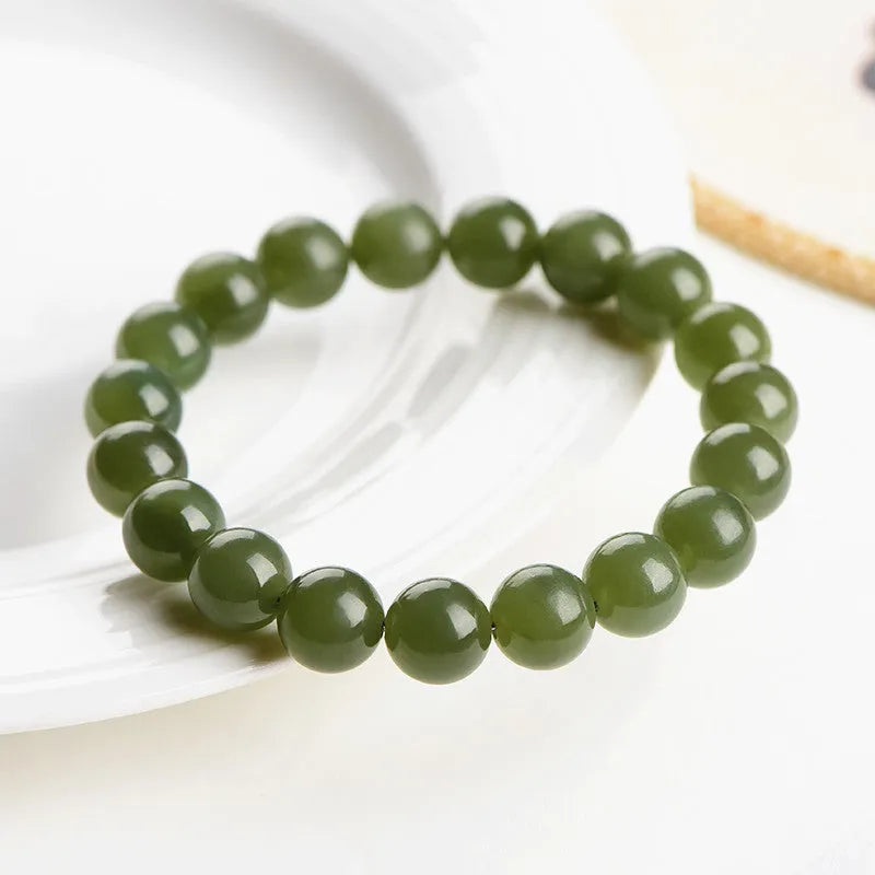 Polished Hetian jade bead bracelet in ice-like clear water colour on a wrist.
