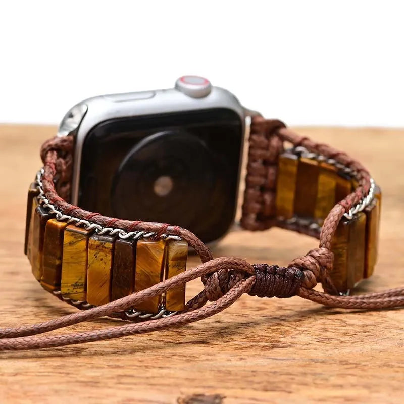 Men's adjustable textile watch strap with rectangular tiger eye stone, showing bohemian design and clasp detail.