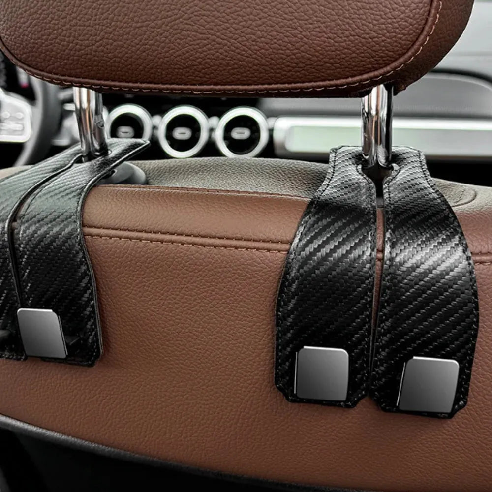 Black carbon fibre metal car hook clipped to headrest with 25kg load capacity