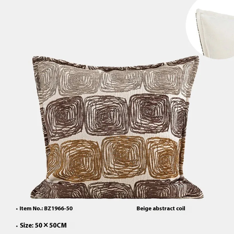 Abstract coil pattern pillow cover in cream and coffee colours on grey sofa